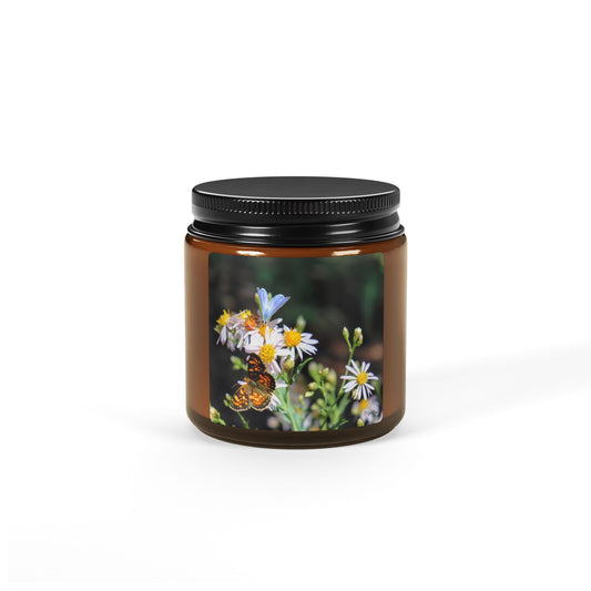Amber glass candle jar with butterfly and wildflower macro photography label