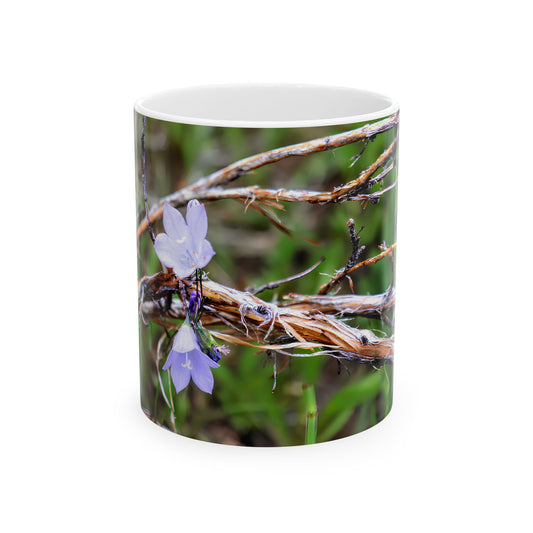 Ceramic mug with macro photo of purple wildflowers and weathered twigs on green background