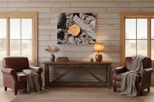 Modern rustic living room with brown leather chairs, wood furniture, and macro leaf wall art.