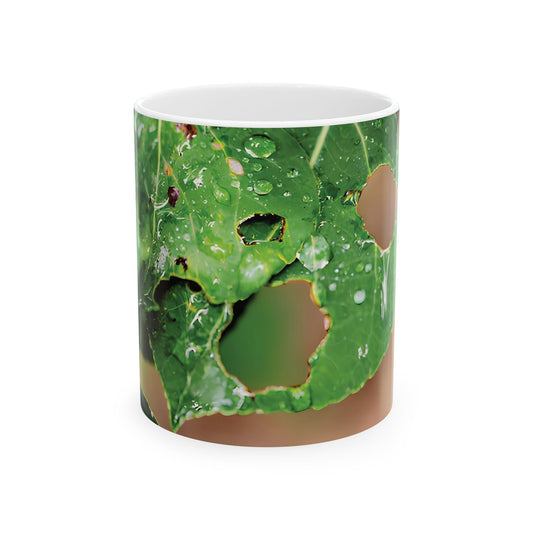 Mug with macro photo of green leaves with raindrops and insect holes